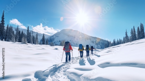 Group of hikers journeying through deep snow beneath a radiant sun, with snow-covered mountains and tall pine trees in the background.