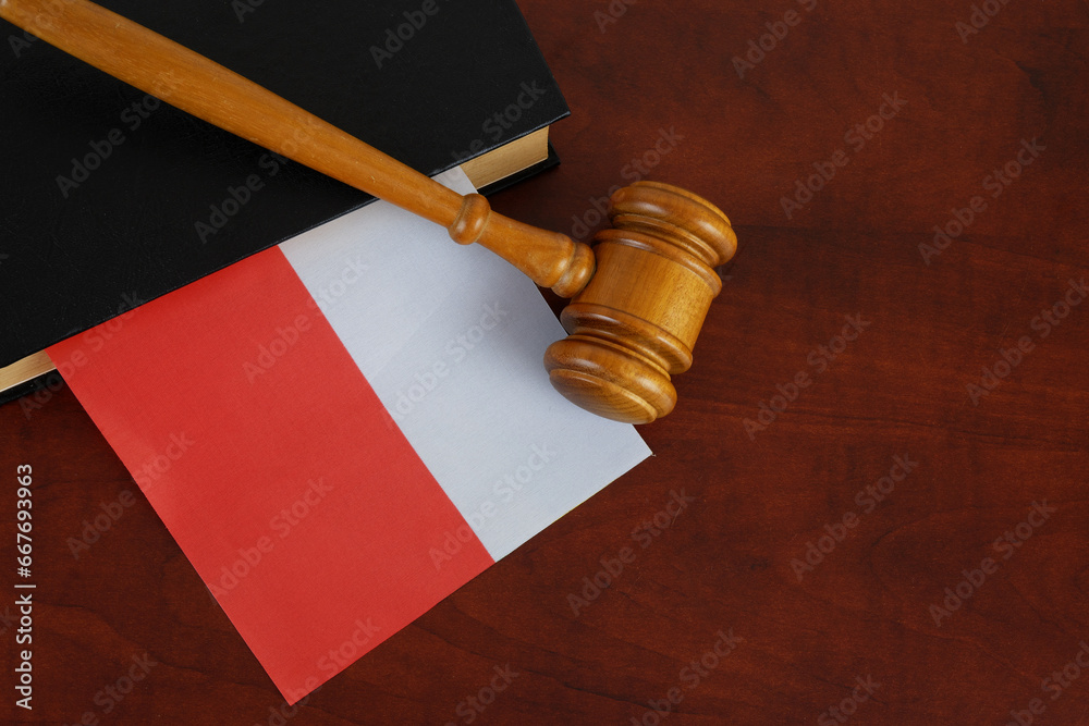 Judge gavel and legal book with flag of Poland on wooden table. Copy space for text.