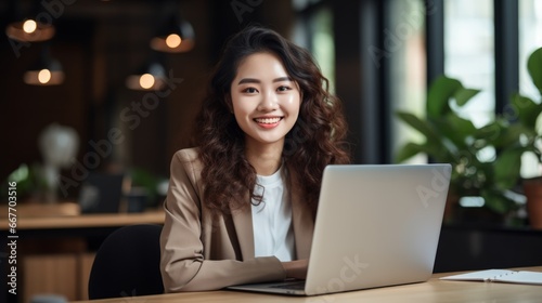 Smiling Teen Chinese Woman with Brown Curly Hair Photo. Portrait of Business Person in the office in front of laptop. Photorealistic Ai Generated Horizontal Illustration.
