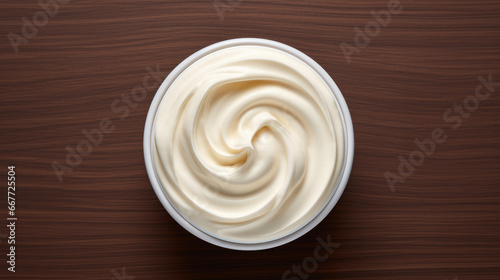 Sour cream in a bowl on a wooden background