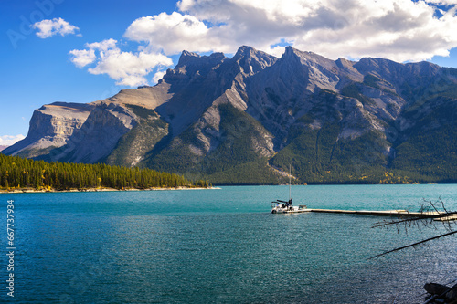 Boat with tourists on Lake Minnewanka in Banff National Park, Canada. Minnewanka is a glacial lake and the 2nd longest lake in the mountain parks of the Canadian Rockies.