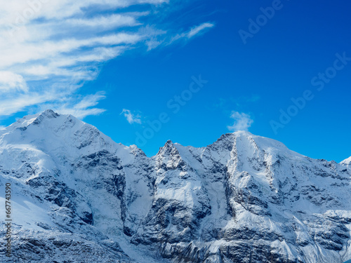 Close view of Piz Morteratsch on the right, Piz Prievlus in the middle and Piz Bernina on the left, against blue sky background. photo