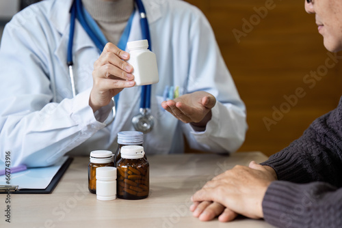 Female doctor are advise medication and vitamin daily to elderly patient