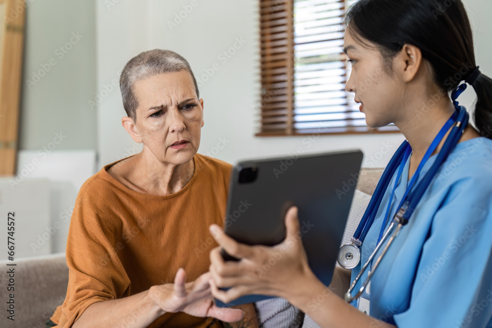 Asian nurse showing health checkup report to older and giving advice. Home nursing and healthcare caregiver concept Asian nurse showing health checkup report to older and giving advice. Home nursing and healthcare caregiver concept