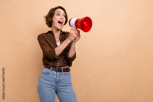 Photos Photo of shiny excited girl dressed brown shirt screaming bullhorn empty space i