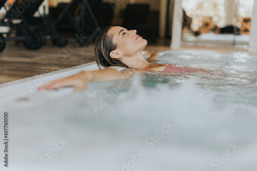 Young woman relaxing in the indoor swimming pool