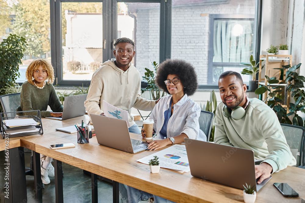 cheerful good looking friends in casual urban attires smiling happily at camera, coworking concept cheerful good looking friends in casual urban attires smiling happily at camera, coworking concept