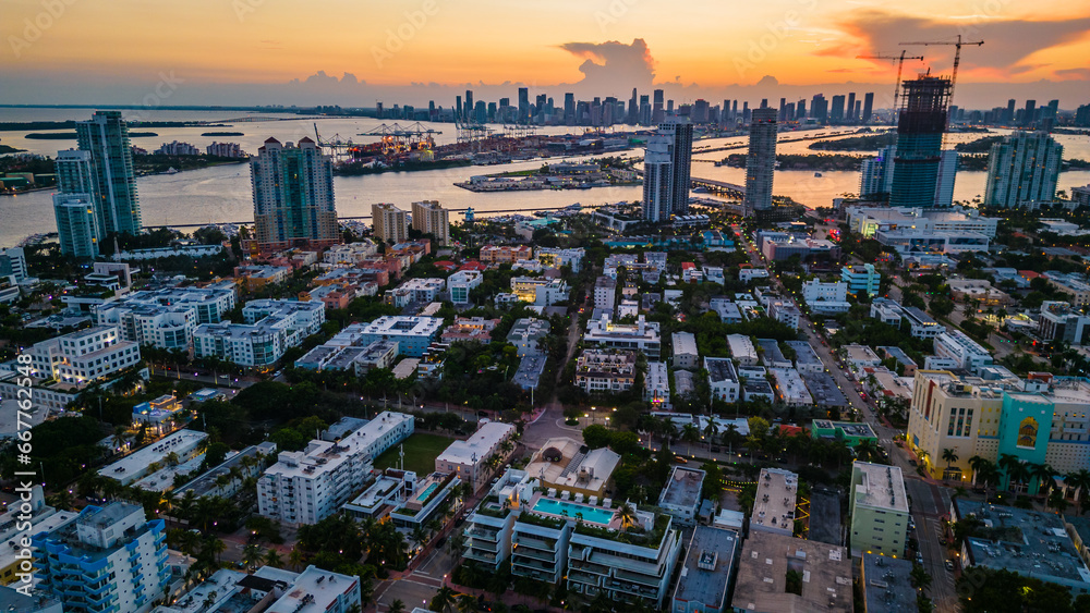 Obraz premium aerial establishing overview of Miami South Beach district at dusk, flashing building lights