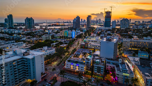 south Beach illuminated at night with cityscape skyline restaurant and ocean drive road © Michele