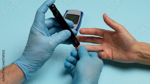Doctor checking blood sugar level with glucometer.