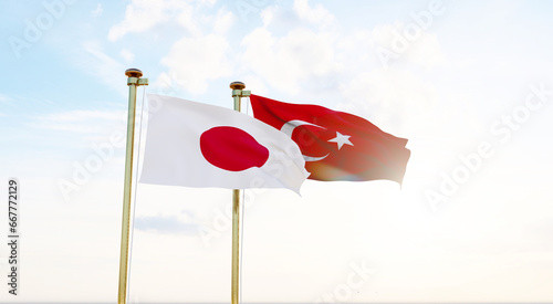 Turkey and Japan Flags are waving in the spring of the blue sky.