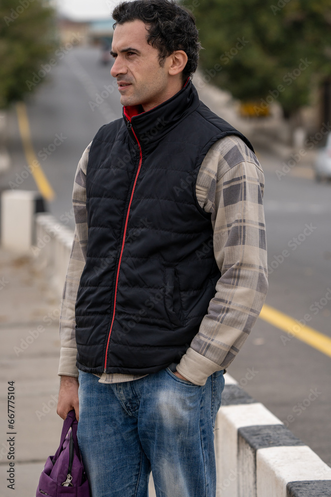 Armenian man, different emotional face actions, in the outdoor, the cold temperature, with the jacket, with the bag in the roadside Armenian man, different emotional face actions, in the outdoor, the cold temperature, with the jacket, with the bag in the roadside
