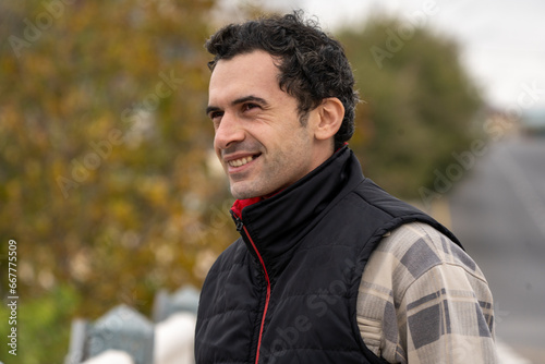 Armenian man, different emotional face actions, in the outdoor, the cold temperature, with the jacket, The Smiling guy joking with friend