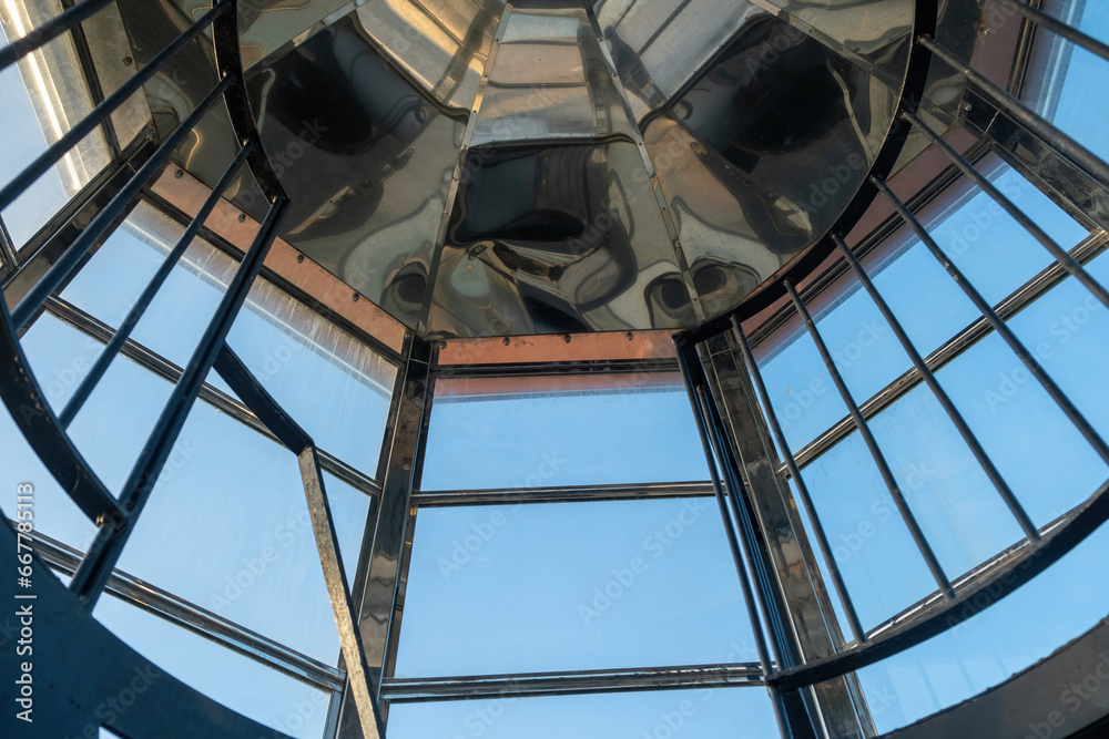 Fototapeta premium Interior top of Gavdos Lighthouse, Crete Greece. Metal reflective frame construction and blue sky.