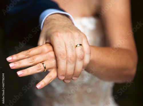The groom takes the bride's hand-