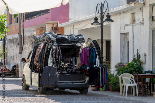 Mochos, Crete, Greece.  30.09.2023.  Mobile van with a collection of clothing sold door to door in the small town of Mochos, Crete.
