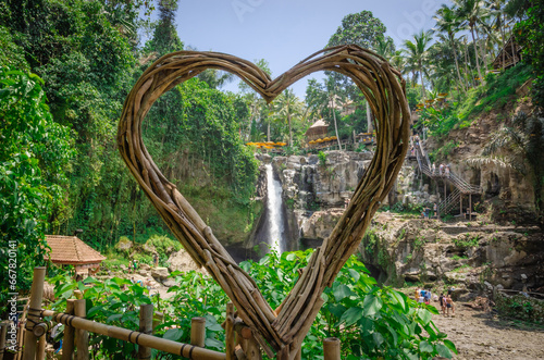 Beautiful Tegenungan waterfall in tropical rainforest in Bali, Indonesia photo