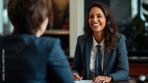 A young professional meeting with a career counselor for job search guidance and smiling.