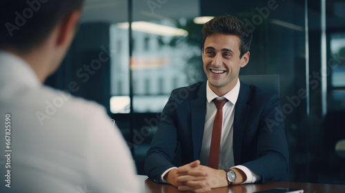 A pleased entrepreneur seeking business advice from a seasoned advisor and smiling.