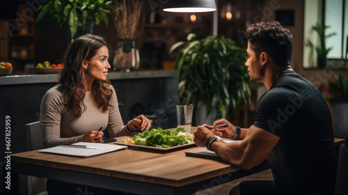 A fitness instructor meeting with a nutritionist to create personalized meal plans.