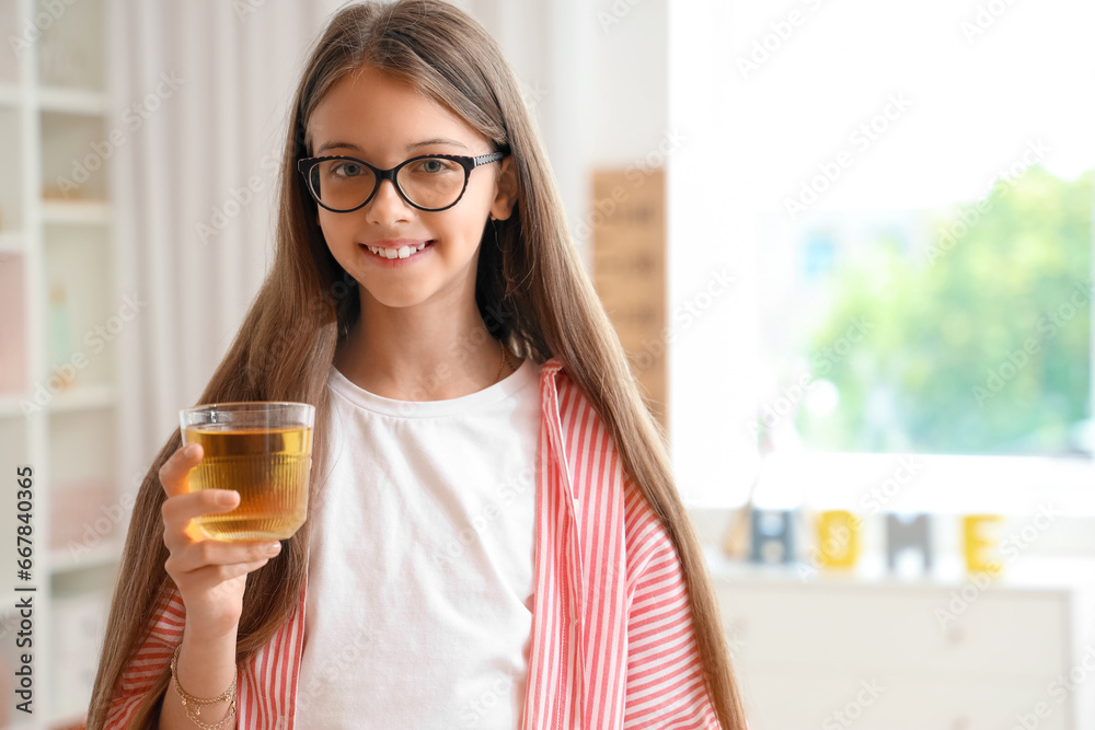 Little girl with glass of juice at home Little girl with glass of juice at home