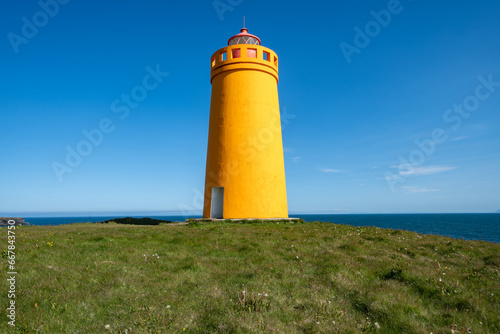 Holmsberg Lighthouse  an orange light house on the Reykjanes Peninsula in Iceland