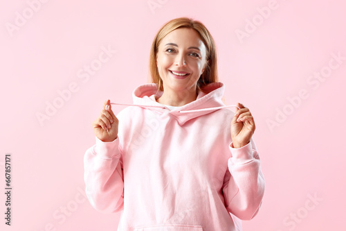 Mature woman in hoodie on p...