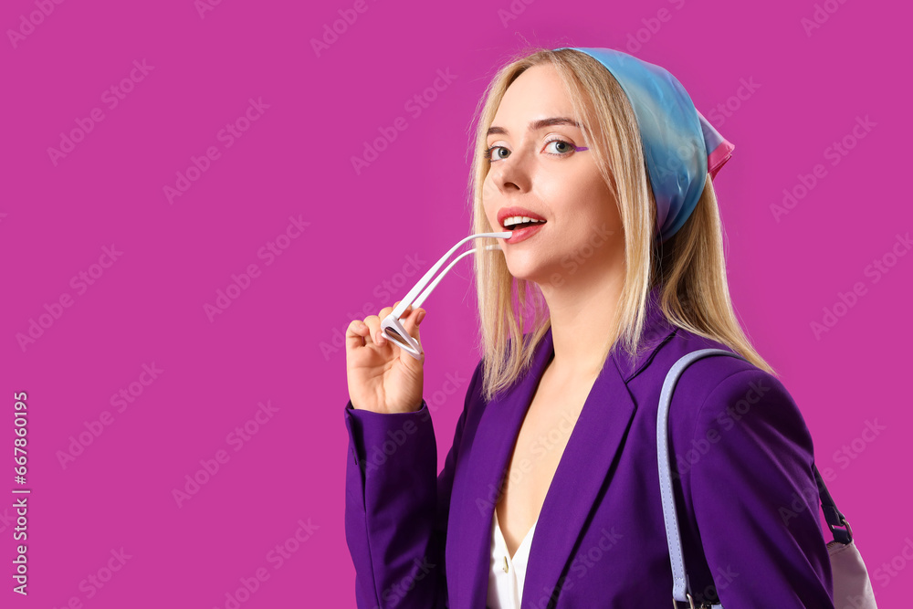 Beautiful young woman with stylish accessories on purple background Beautiful young woman with stylish accessories on purple background