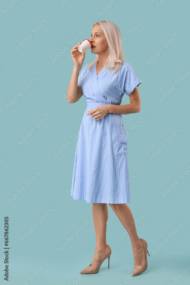 Mature woman drinking coffee on blue background Mature woman drinking coffee on blue background