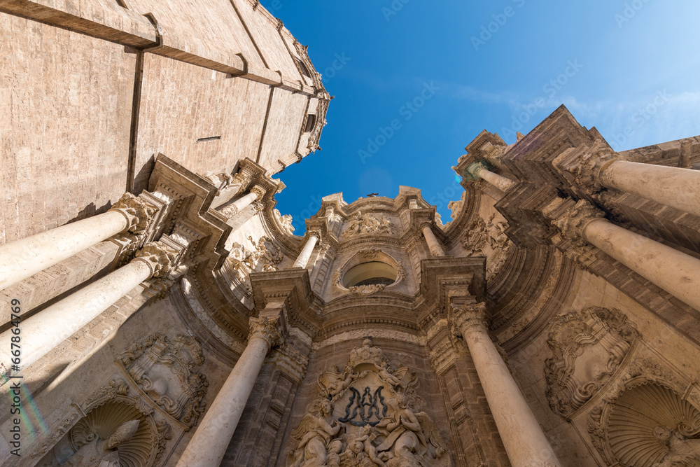 Valencia, Spain - September 23th, 2023: Bottom up view of Valencia Cathedral with its bell tower El Miguelete. Gothic style tower with the shape of an octagonal prism.
