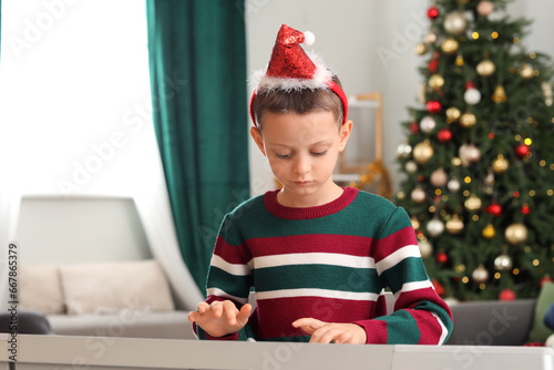 Cute little boy playing syn...