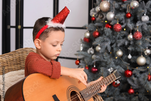 Cute little boy playing gui...