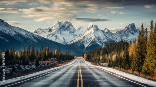 View of road leading towards snowy mountains photo