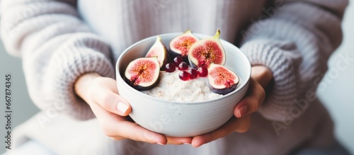 Winter breakfast with rice coconut porridge figs berries and hazelnuts Promoting clean eating vegetarian vegan alkiline diet photo