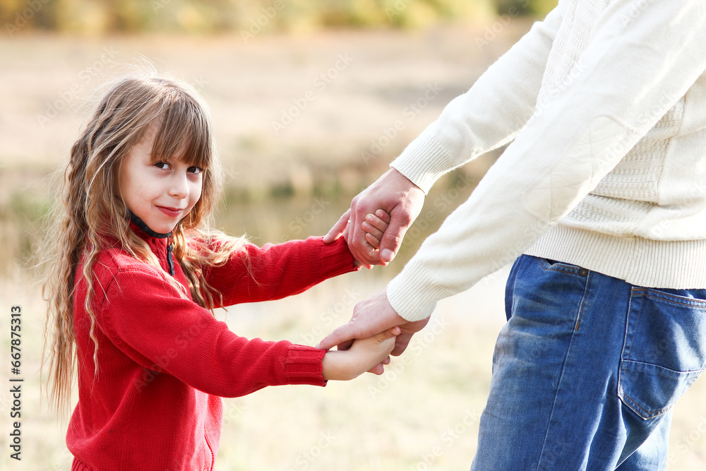 Fototapeta premium father holding child's hand concept family support