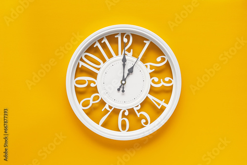 Circle clock on yellow background wall