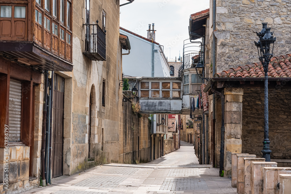 Picturesque alley with old stone houses in the medieval village of Salvatierra, Basque Country, Spain.