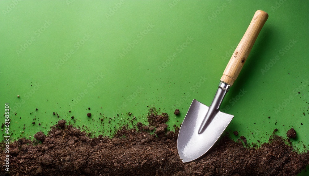 garden shovel with dirt on green background garden shovel with dirt on green background