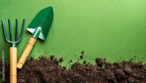 garden shovel with dirt on green background photo