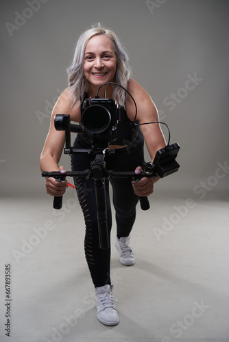 Woman videographer with gimbal and camera