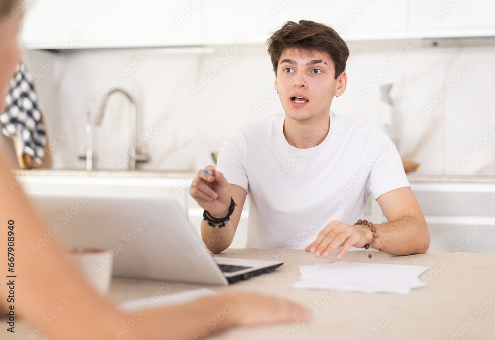 Adult woman while discussing deal with salesman in kitchen