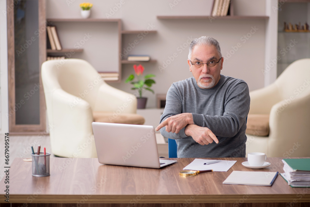 Old male employee working from home during pandemic Old male employee working from home during pandemic