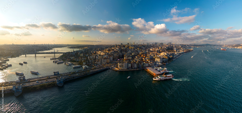Drone view of Galata Bridge and Beyoglu district. A wide panorama of spring Istanbul at sunset.
