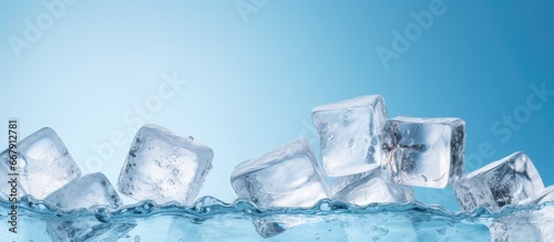 Refreshing and healthy water with ice cubes on a blue background