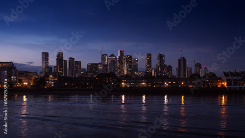 Night view on Isle of Dogs and Canary Wharf from the bank of the Thames river, Grivich district. 16x9 photo