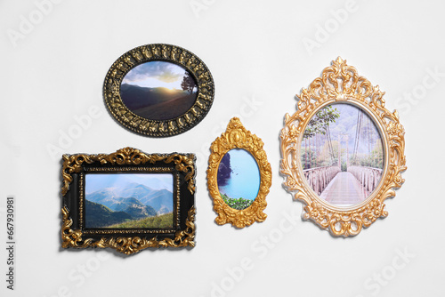Vintage frames with photos of beautiful landscapes hanging on white wall