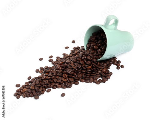 Coffee beans and overturned cup isolated on white