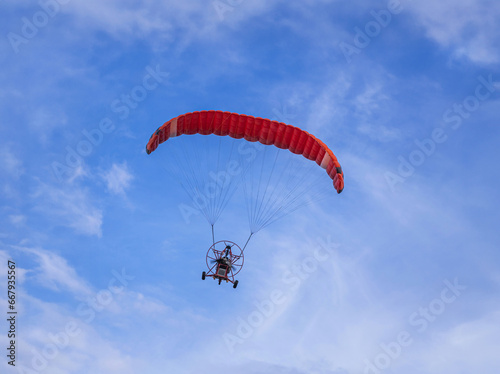 Paramotor or paragliding flying in the air on  blue  sky  