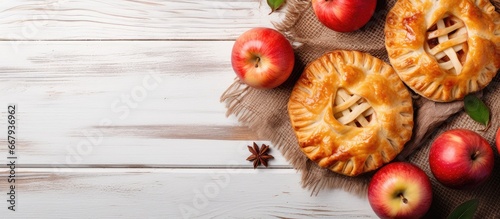 Top view of homemade organic apple pies on a white wooden background a classic autumn Thanksgiving dessert