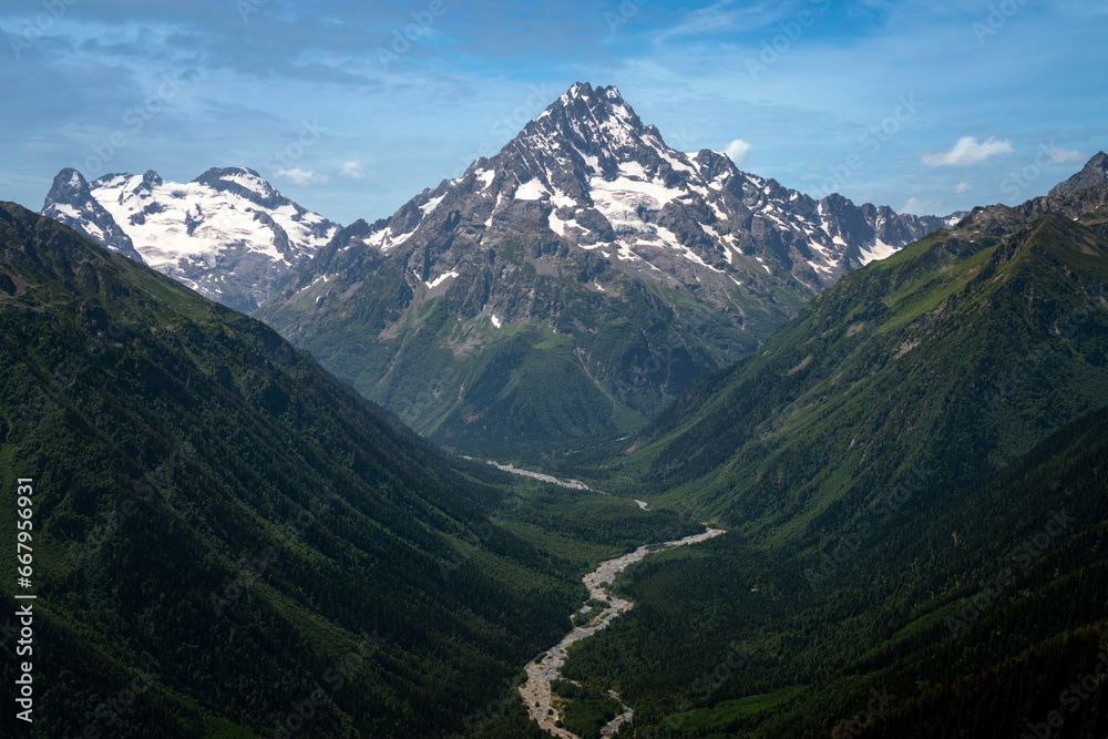 Naklejka premium View of Mount Pshish - the highest peak near the village of Arkhyz and the valley of the Psysh River on a sunny summer day, North Caucasus, Karachay-Cherkessia, Russia